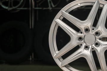 alloy wheel silver, rim new car wheel on a black background close up. Copyspace copy space, front...