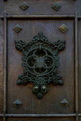 Ancient metal decorative door handles Castle Hluboka, historic chateau in Hluboka nad Vltavou, South Bohemia, Czech Republic. Close-up.