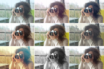 Curly haired photographer woman holding her camera in a cafe and shooting
