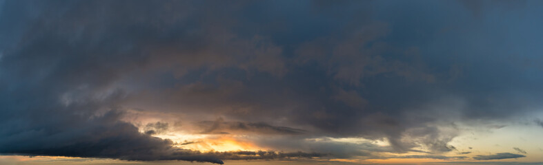 Fantastic dark thunderclouds at sunrise