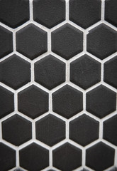 Black ceramic cells on the wall as background