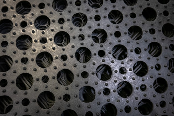 Perforated metal pattern background. Black and gray metal background.