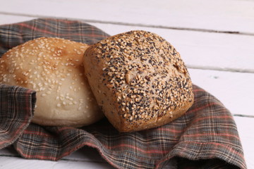 delicious bread rolls on colored background