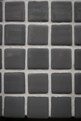 Gray ceramic mosaic on the wall as background