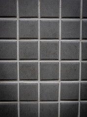 Gray ceramic mosaic on the wall as background