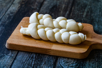 Turkish Knitting / Knitted Cheese on Wooden Board.