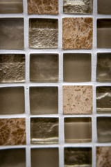 Brown ceramic mosaic on the wall as background