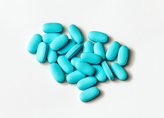 Obraz na płótnie Canvas Blue pills on a white background