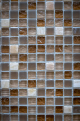 Brown ceramic mosaic on the wall as background