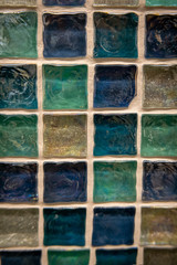 Green ceramic mosaic on the wall as background