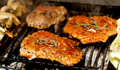 meat with  herbs grilling on barbecue