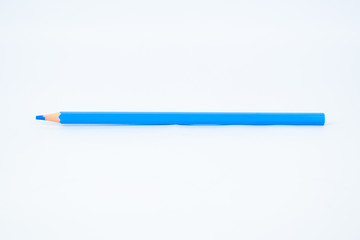 Light blue colored sharp wood pencil crayon isolated on a white background