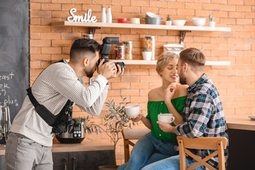 Photographer working with young couple in studio