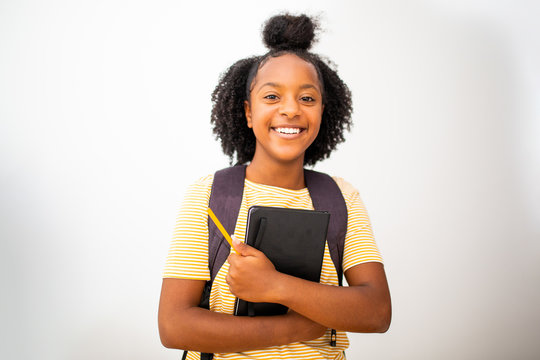 Happy African American Girl Student With Bag And Books By Isolated White Background