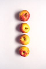 Overhead View Of Line Of Fresh Apples Against White Background