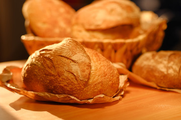 Assortment of baked bread on wooden table background. Bread background, top view of white, black and rye loaves. Healthy food. 