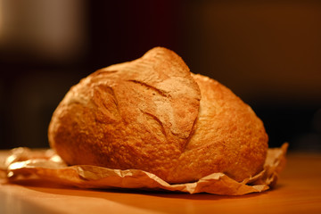 Assortment of baked bread on wooden table background. Bread background, top view of white, black and rye loaves. Healthy food. 