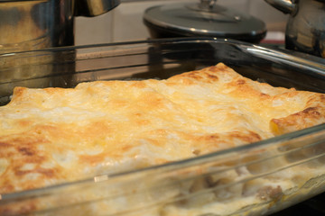 glass culinary container with baked fresh hot lasagna