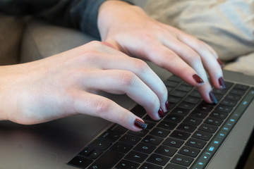 Female hands typing on computer keyboard