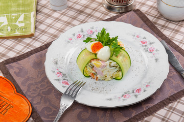 Olivier salad on a tablecloth in a brown cage