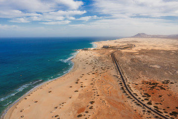 High angle view of road going through Corralejo dunes nature park in Fuerteventura. Aerial drone shot in october 2019