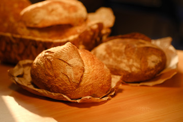 Assortment of baked bread on wooden table background. Bread background, top view of white, black and rye loaves. Healthy food. 