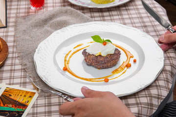 steak with poached egg in a brown cage