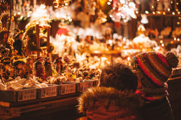 Children enjoying the Christmas stalls on the Christmas Market of Bruges, Belgium, Europe - obrazy, fototapety, plakaty