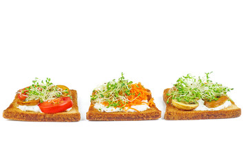 Bread pieces with delicious cod caviar and vegetables on white background