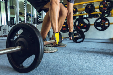 Fototapeta na wymiar sportsman lifting a barbell at the gym