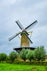Obraz premium Goes, the netherlands, august 2019. In the countryside of the zealand region, a perfectly preserved and functioning windmill. Typical postcard landscape of the Dutch countryside.