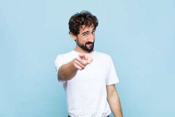 young crazy bearded man pointing at camera with a satisfied, confident, friendly smile, choosing...