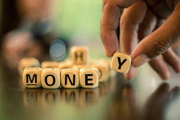 wood cube word "money" and tax on the table