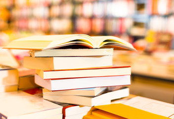 stack of books lying on table in bookstore