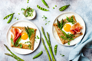 Buckwheat crepes, galette bretonne with asparagus, egg, green pea, jambon or prosciutto. Galette sarrasin, french brittany cuisine