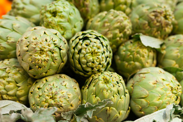 Fresh artichokes on market counter