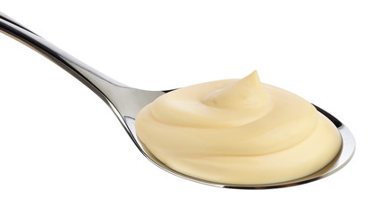 Mayonnaise in spoon isolated on white background