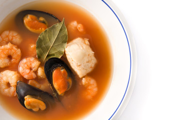 French bouillabaisse soup in white plate isolated on white background.Top view. Copy space