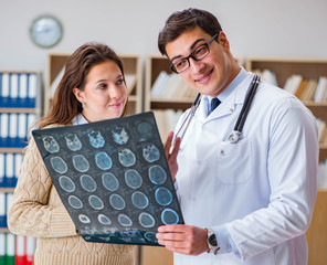 Young doctor looking at computer tomography x-ray image
