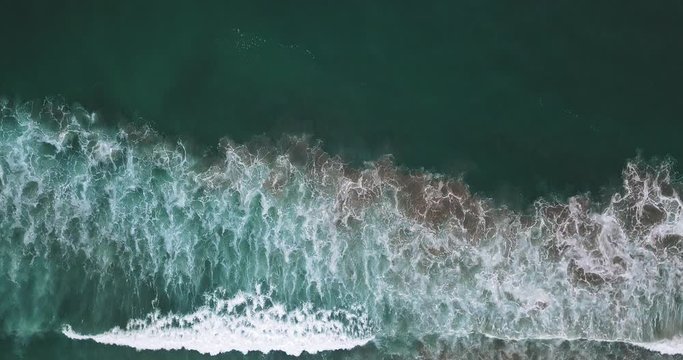 Blue and green ocean with white wawes.