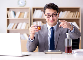 Young businessman drinking from stress