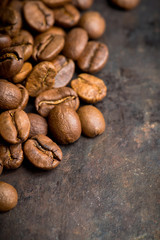 Coffee beans on the rustic wooden background. Selective focus. Shallow depth of field.