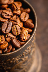 Coffee beans on the rustic wooden background. Selective focus. Shallow depth of field.