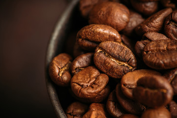 Coffee beans on the rustic wooden background. Selective focus. Shallow depth of field.
