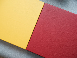 Cover for photo album or photo book. Texture of genuine leather yellow and red colors. Yellow and red genuine leather.