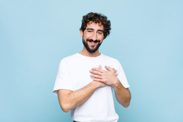 young crazy bearded man feeling romantic, happy and in love, smiling cheerfully and holding hands...
