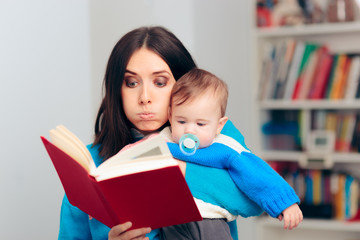 Fototapeta premium Funny Mother Reading Fairytale Book To her Baby