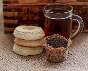 Bag of dry Kenia tea,in back glass of tea and cookie