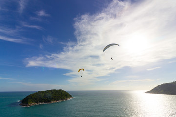 Two paragliders over the small island