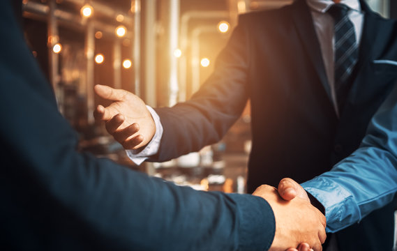 Business shaking hands, finishing up meeting. Successful businessmen handshaking after good deal.
